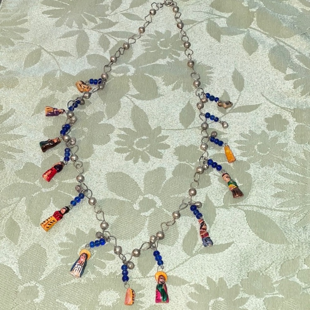 Nativity scene necklace and 25 inches in length.